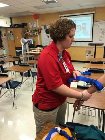 Nurse giving stop the bleed instructions