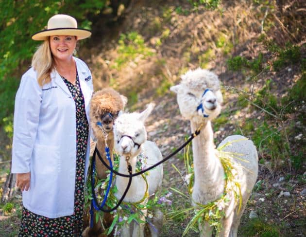 Women with two alpacas